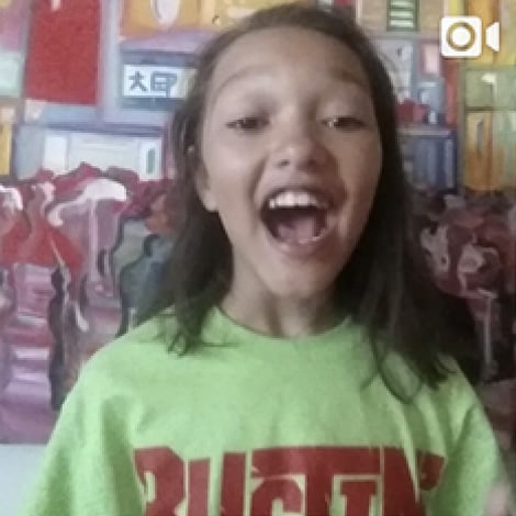 Happy girl wearing Bustin Barriers t-shirt