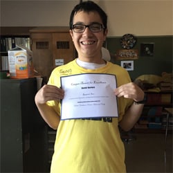 Kid showing certificate and looking proud