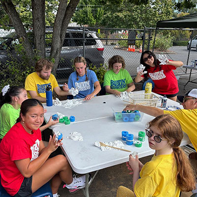 campers crafting outside at a table