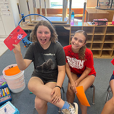 goofing around and crafting at camp