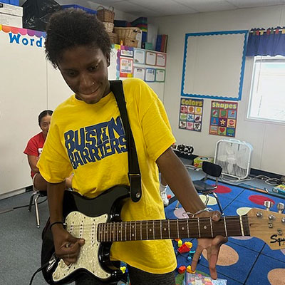 playing electric guitar at camp